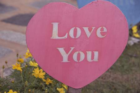 background of Valentine's Day. red hearts on a wooden backgroundの写真素材