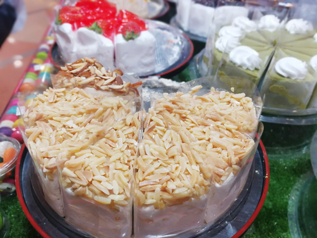 orange butter cake topping peanut and dried fruit salad on plateの写真素材