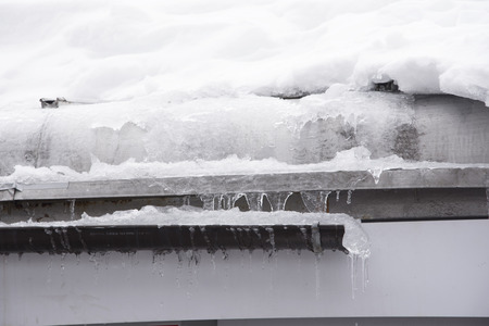 The village roof is filled with white winter snow patterns.