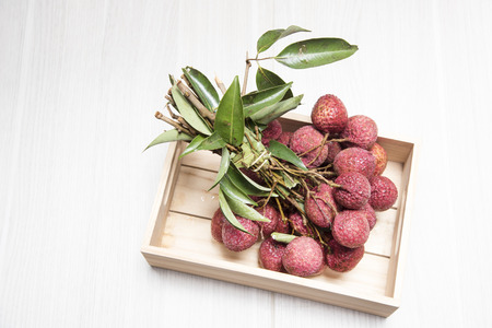 fresh lychees in a wooden box as background or wallpaper