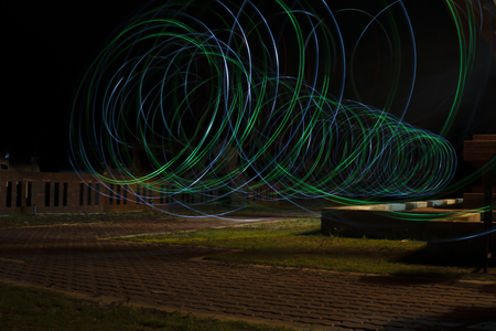 Light bulbs and colored lights that are rotating on a black background