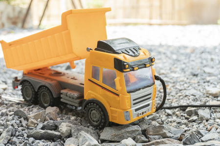 Children's loader plays on the rocky floorの写真素材