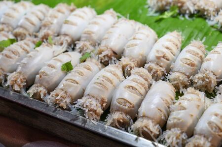 Busy grilled squid stuffed with noodlesの写真素材