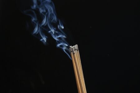 Incense and smoke on a black backgroundの写真素材