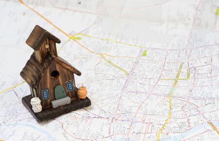 Home model with dollars and maps