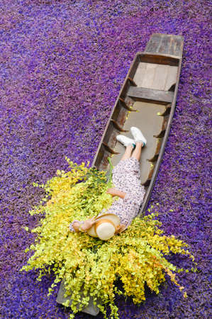 A boat with yellow flowers on an old wooden boat on a natural background