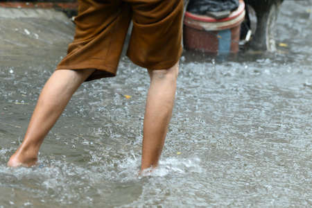 Legs walking in the flooding water in Thailand