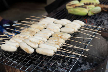 Grilling bananas on the stove for sale in Thai food market marketsの写真素材