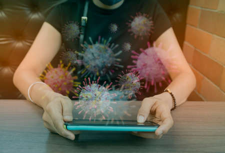 A girl who does not see a face is playing with a smartphone background The Covid-19 corona virus in lifestyle, technologyの写真素材