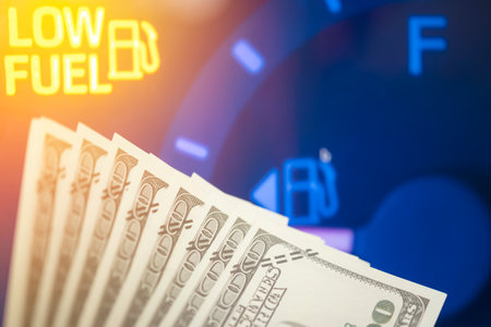 Dollar bank money coming from car fuel mileage dashboard concept closed on financial backgroundの写真素材