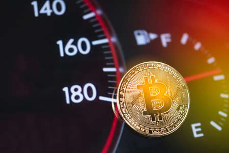 Bitcoin, derived from the concept of a dashboard, car fuel mileage, closed on a financial background.の写真素材