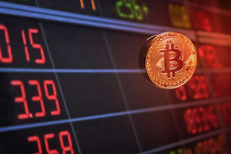 Golden Bitcoins and electronic money concept with graphs. Stock on business and finance backgroundの写真素材