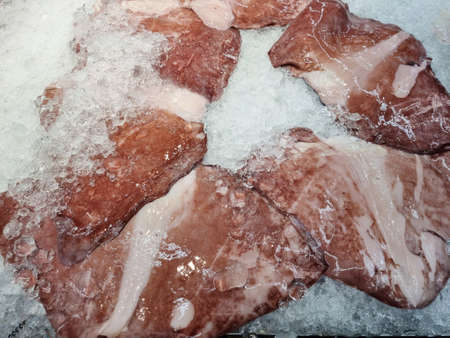 Lots of fresh sliced octopus meat on the background.の写真素材