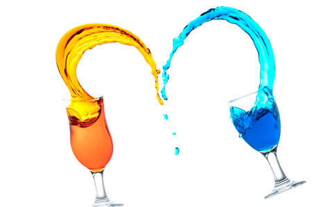 Cocktail glass with colorful liquor splashed at close distance, isolated on whiteの写真素材