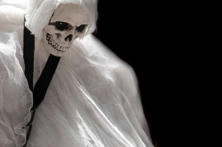 Ghost with human skull white cloth in darkness on grunge halloween backgroundの写真素材