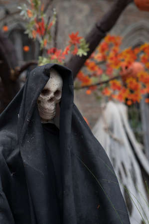Halloween human skull abscess in black cloak concept on copy spaceの写真素材