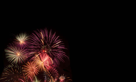 colorful new year holiday fireworks on black background with copy space