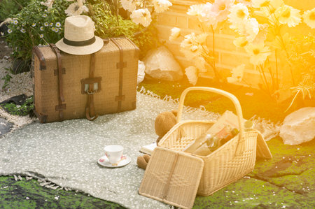 woven bag with hat Plaid in a basket standing on a picnic abstract background.の写真素材