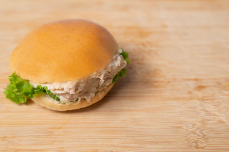 Side view of tuna burger on wooden table with background copy spaceの写真素材
