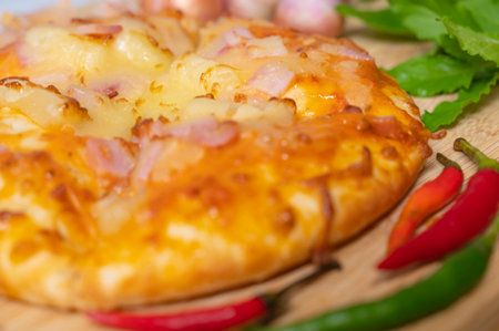 Pizza background in close up with fresh paprika, garlic, shallots on food background.の写真素材