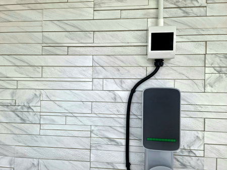 Energy charger on brick wall background, technology backgroundの写真素材