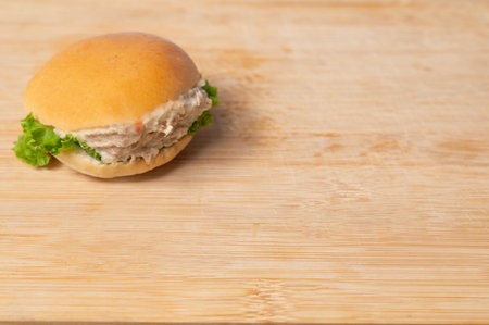 Side view of tuna burger on wooden table with background copy spaceの写真素材
