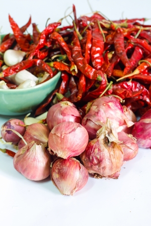 Shallots on white background with Dried Hot Pepper and Allium sativumの写真素材