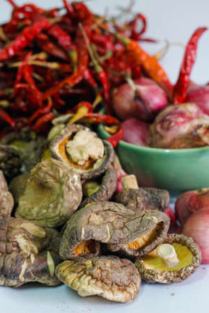 Shiitake mushrooms on the white background with Chili and Shallotsの写真素材