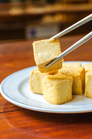 fish Tofu in the plate on a wooden tableの写真素材
