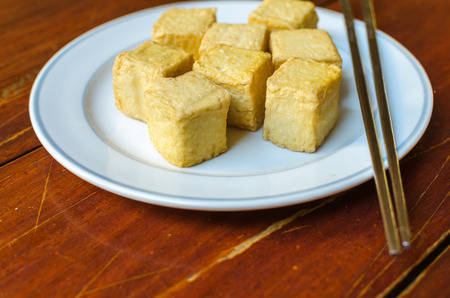 fish Tofu in the plate on a wooden tableの写真素材