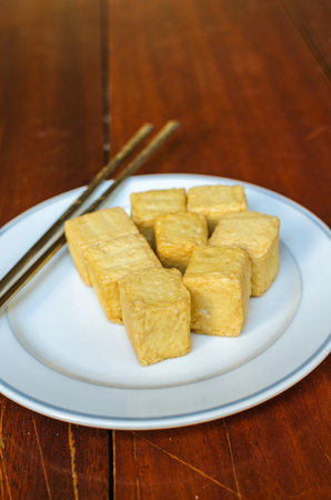 fish Tofu in the plate on a wooden tableの写真素材