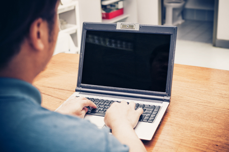 a man working on his laptop in a coffee shopの写真素材