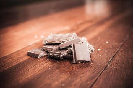 Chocolate on wood background, made vintage color toneの写真素材