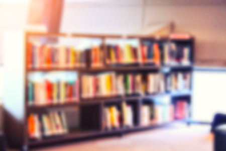 blur image of the library or Book shelf Knowledge and Research in Education and sun lightの写真素材