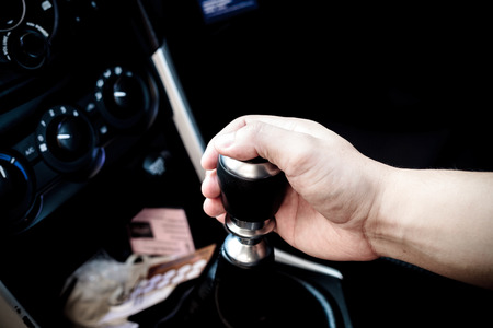 Hand changing a car transmission