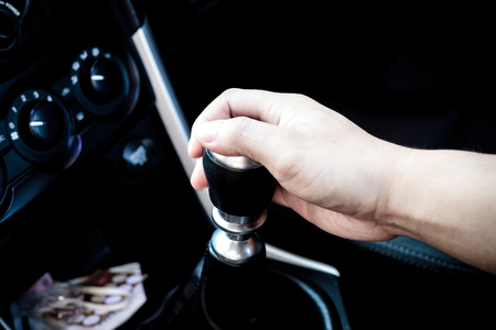 Hand changing a car transmissionの写真素材