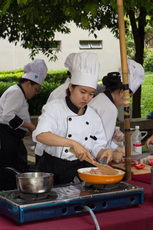 CHIANG-RAI THAILAND-MAY 15: Cooking Competition Students of the School of Tourism Management (Junior Iron Chef) on May 15, 2015 Mae Fah Luang University, Chiang-rai Thailand.のeditorial素材
