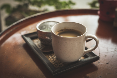 Hot coffee latte or black coffee in the coffee shop, vintage color filter.の写真素材