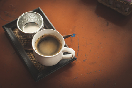 Hot coffee latte or black coffee in the coffee shop, vintage color filter.の写真素材