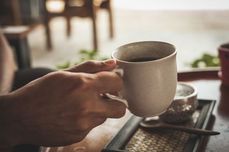 Hot coffee latte or black coffee in the coffee shop, vintage color filter.の写真素材