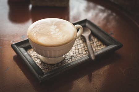 Hot coffee latte or black coffee in the coffee shop, vintage color filter.の写真素材