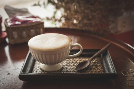 Hot coffee latte or black coffee in the coffee shop, vintage color filter.の写真素材