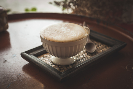 Hot coffee latte or black coffee in the coffee shop, vintage color filter.の写真素材