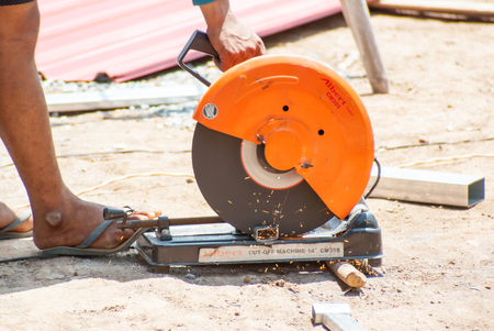 PHITSANULOK - MAY 14: The smith are cutting steel with electric saw. on May 14, 2016 in Phitsanulok, Thailand.のeditorial素材