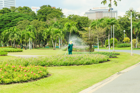 Attractive woman watering the plants in the garden.のeditorial素材
