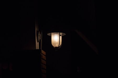 Street lantern on a wall at dark nightの写真素材