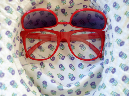 Red sunglasses and a hat の写真素材