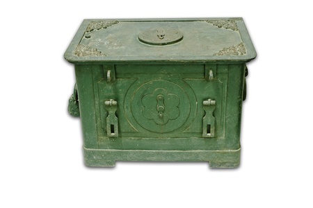The old antique iron safe isolated on whiteの写真素材