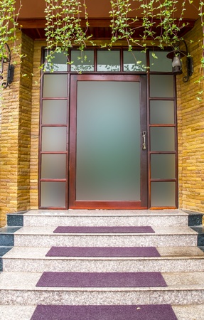 Glass door with building exterior is sandstone の写真素材