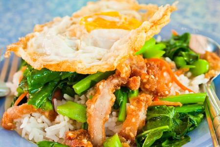 Thai food, kana moo krob  fried kale mixed crispy pork and egg の写真素材
